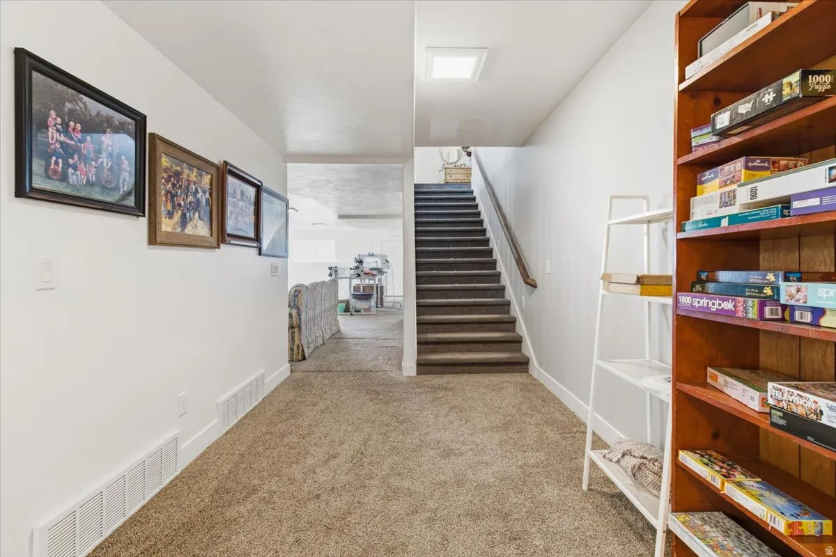 Stairway featuring carpet and baseboards