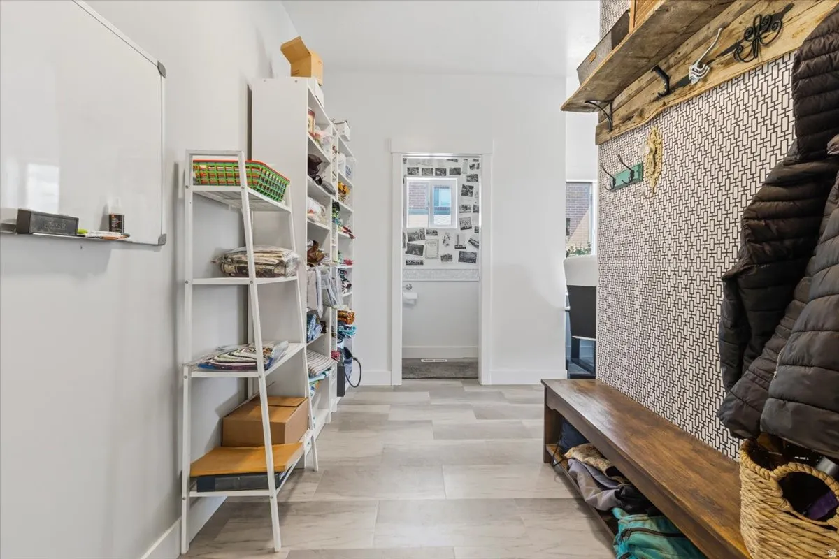 Mudroom with baseboards and light floors