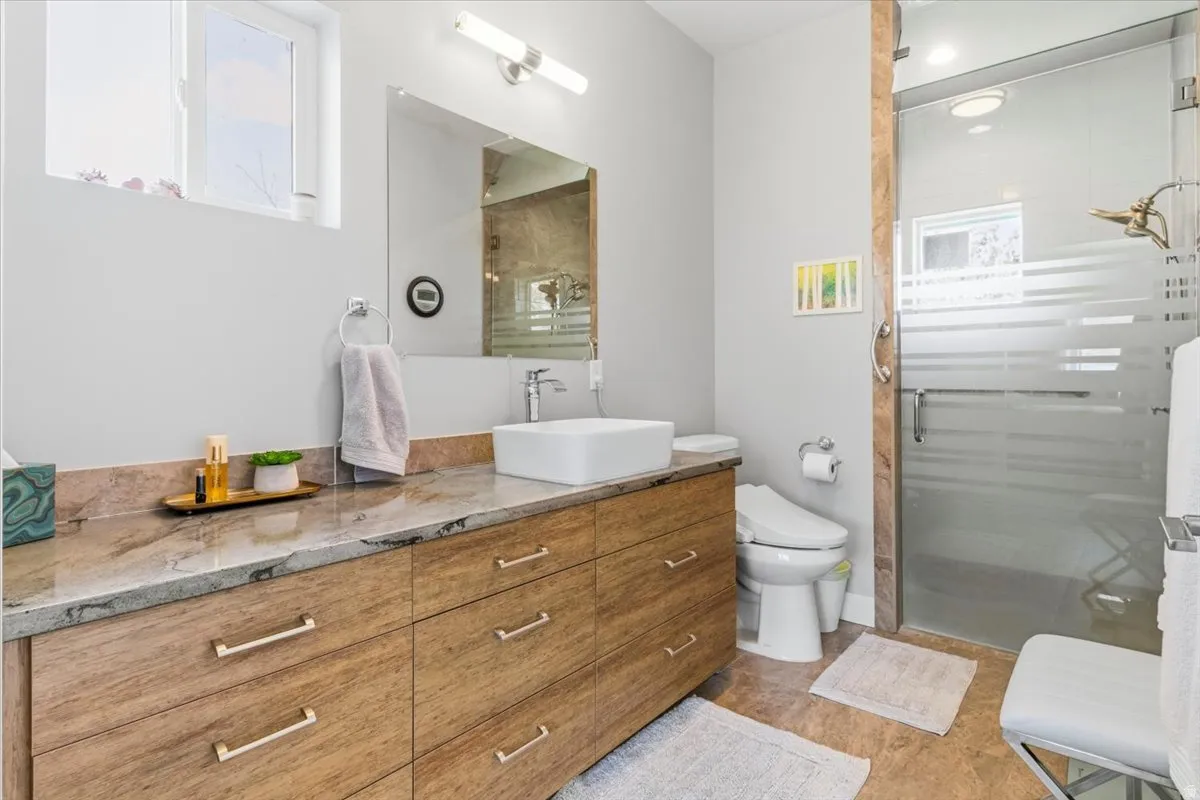 Full bathroom featuring vanity and a shower stall