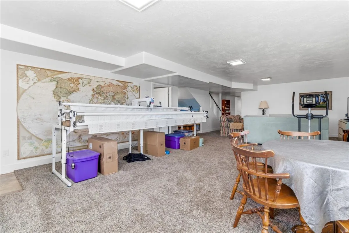 Game room with carpet and a textured ceiling