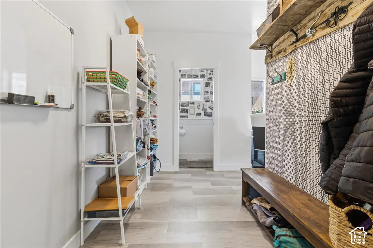 Mudroom with baseboards and light floors