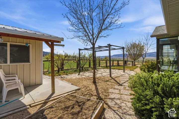 Fenced backyard featuring a patio area and a mountain view