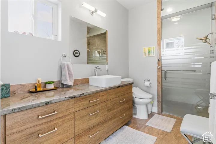 Full bathroom featuring vanity and a shower stall