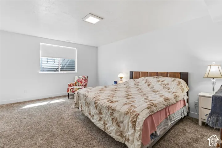 Bedroom featuring dark colored carpet