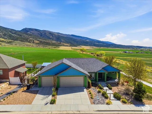 View of front of home featuring an attached garage, driveway, and a mountain view