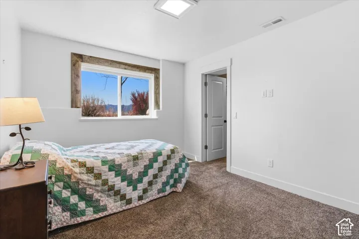 Bedroom with carpet flooring and baseboards