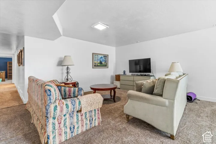 Carpeted living room with baseboards
