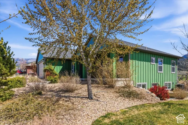 View of front of house featuring board and batten siding and an attached garage