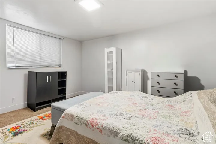 Bedroom featuring carpet flooring and baseboards