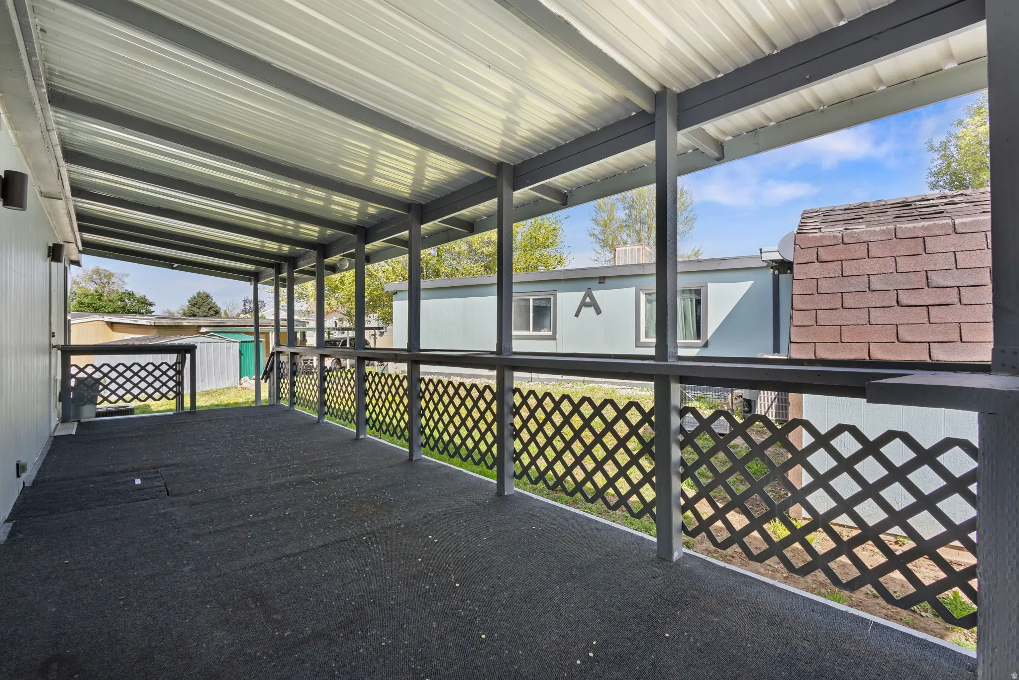 View of patio featuring a storage shed