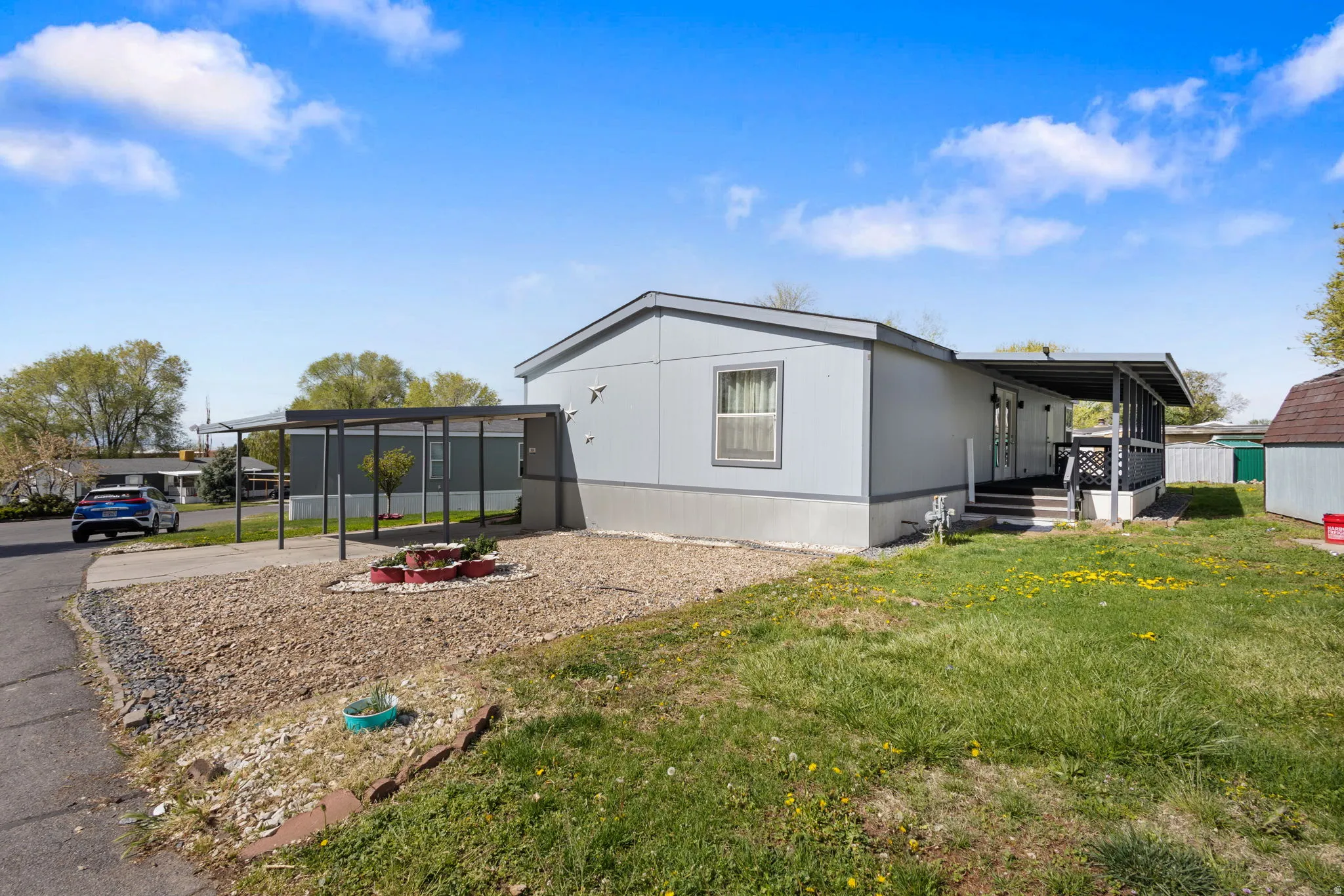 View of home's exterior with a lawn and driveway
