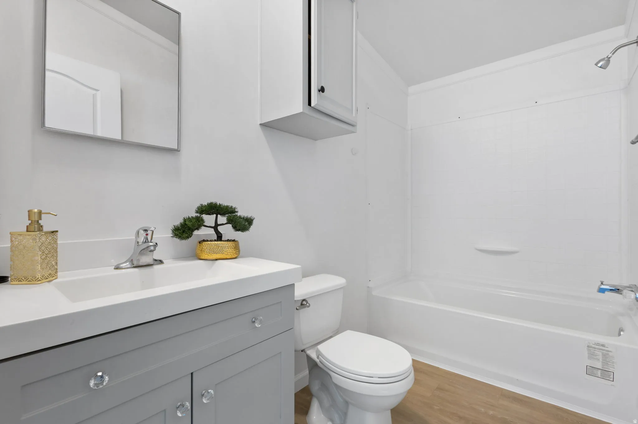 Bathroom with vanity, shower / tub combination, and light wood-type flooring