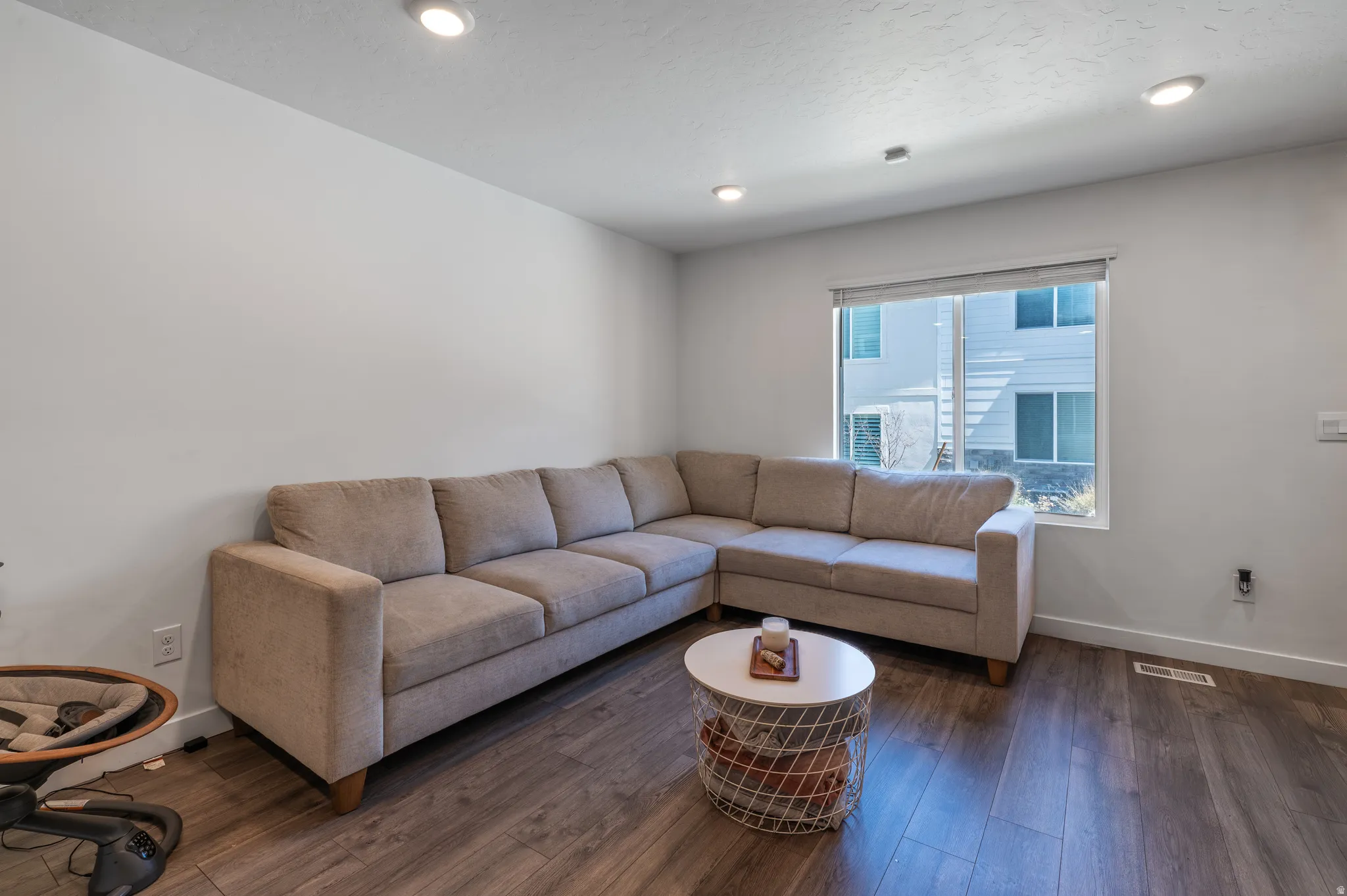 Living room featuring wood-type flooring and recessed lighting