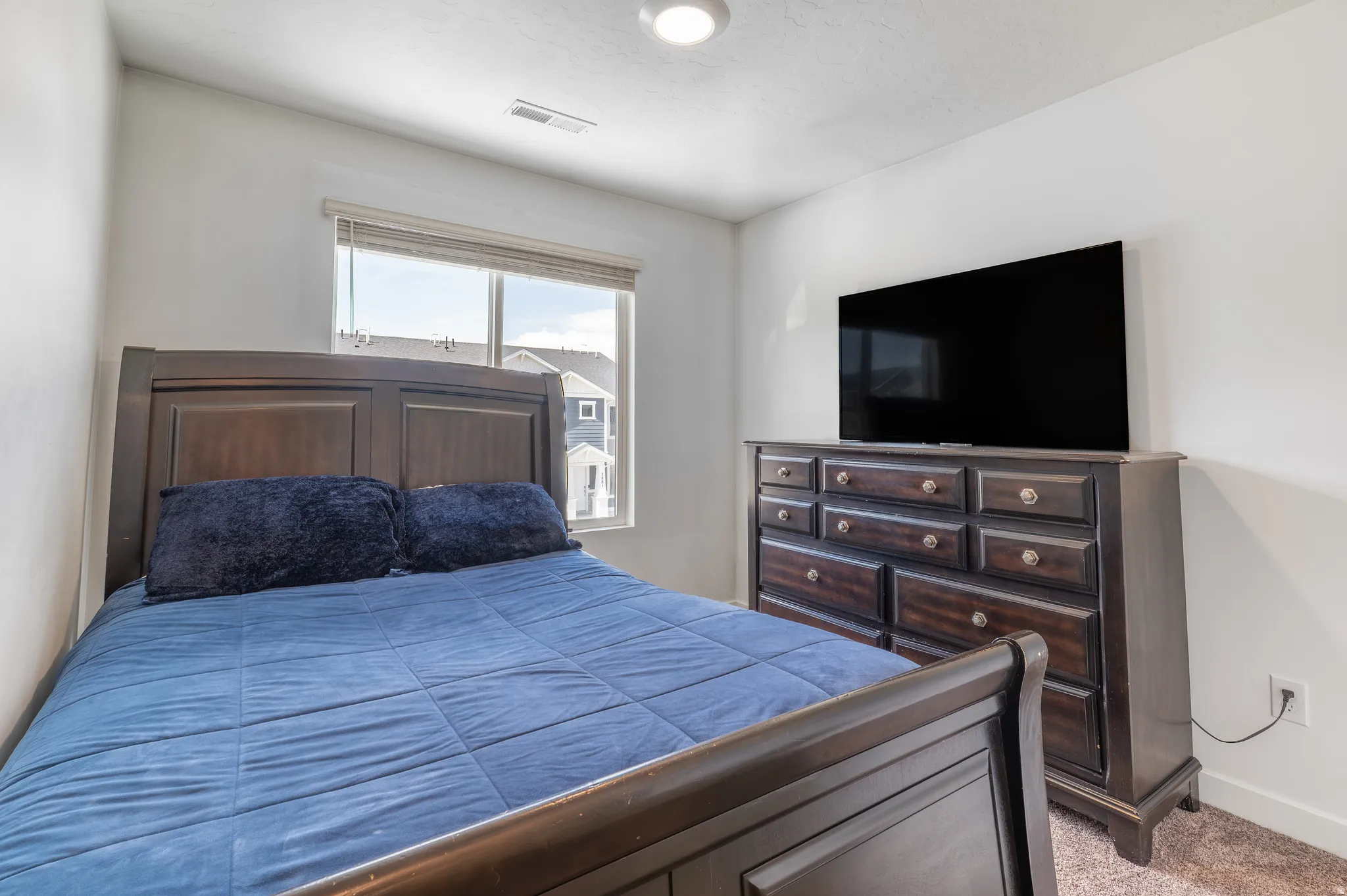 Bedroom with baseboards and light colored carpet