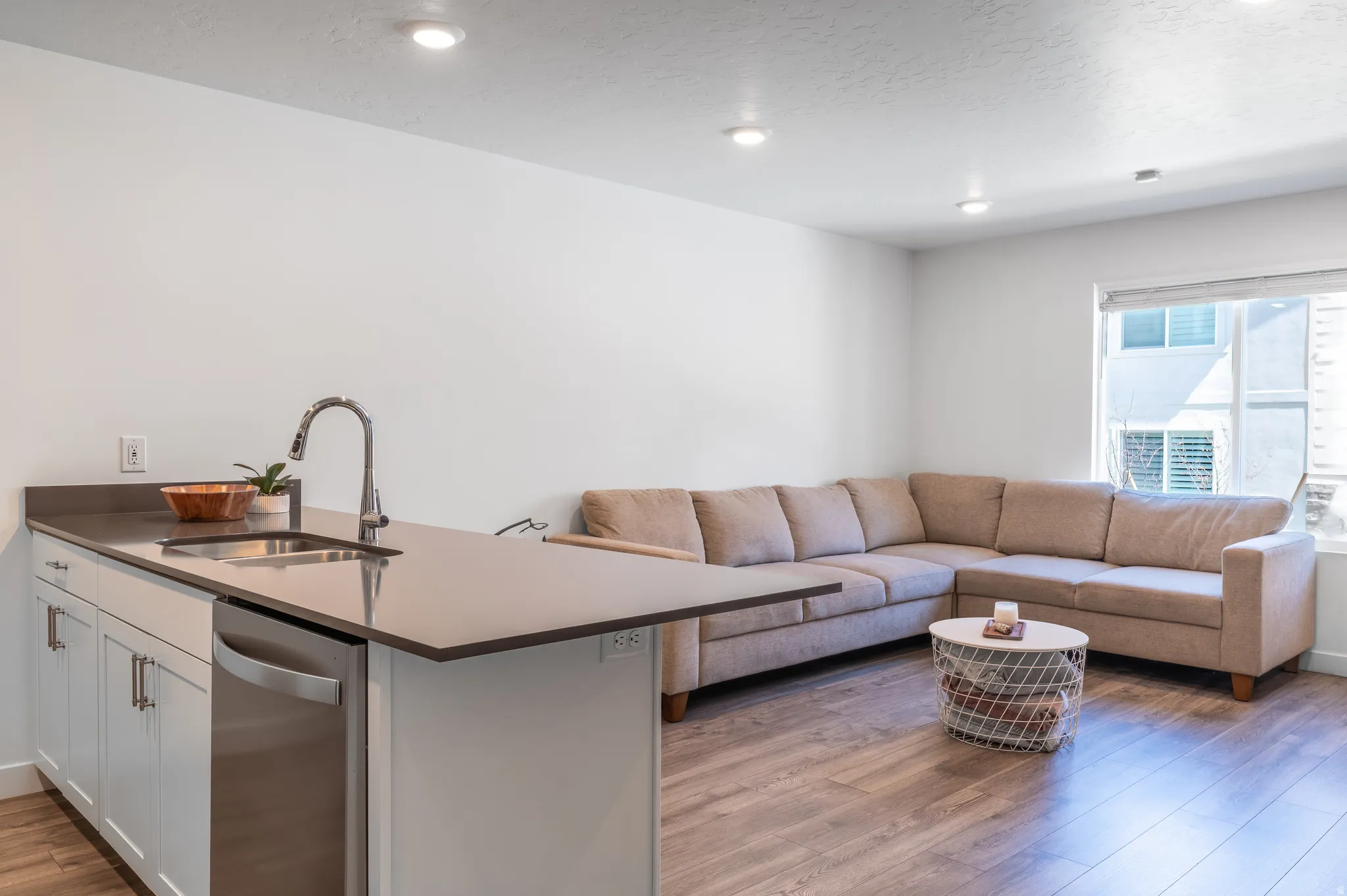 Living room featuring light wood-style flooring and a textured ceiling