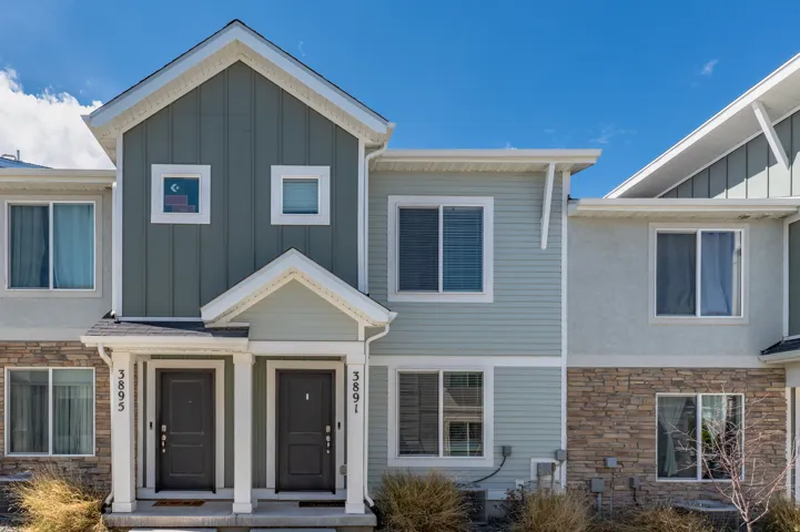 View of front of house featuring stone siding and board and batten siding