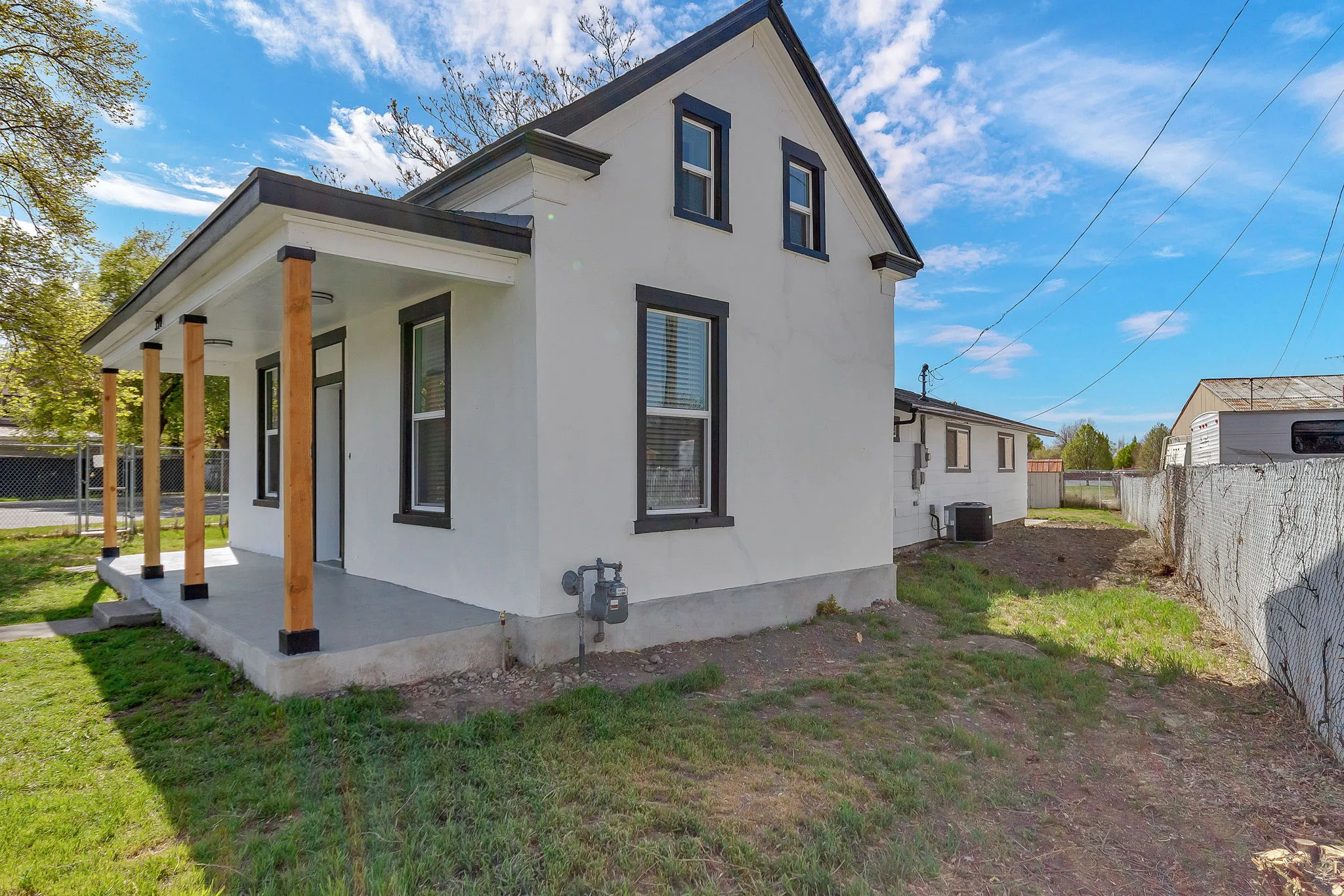 View of property exterior with covered porch and stucco siding