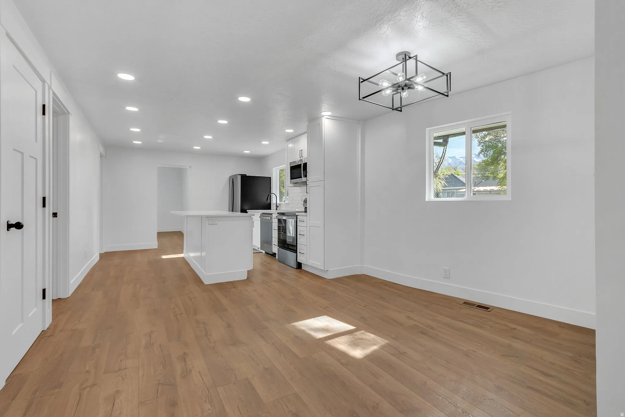 Dining area with light wood LVP finished floors.