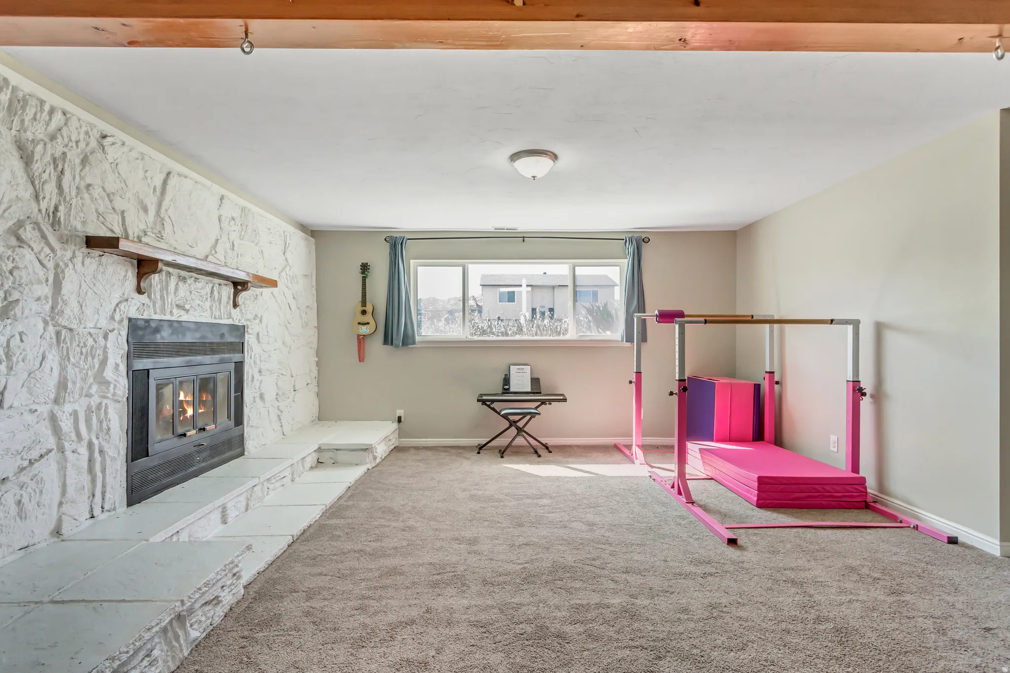Game room featuring carpet floors and a fireplace