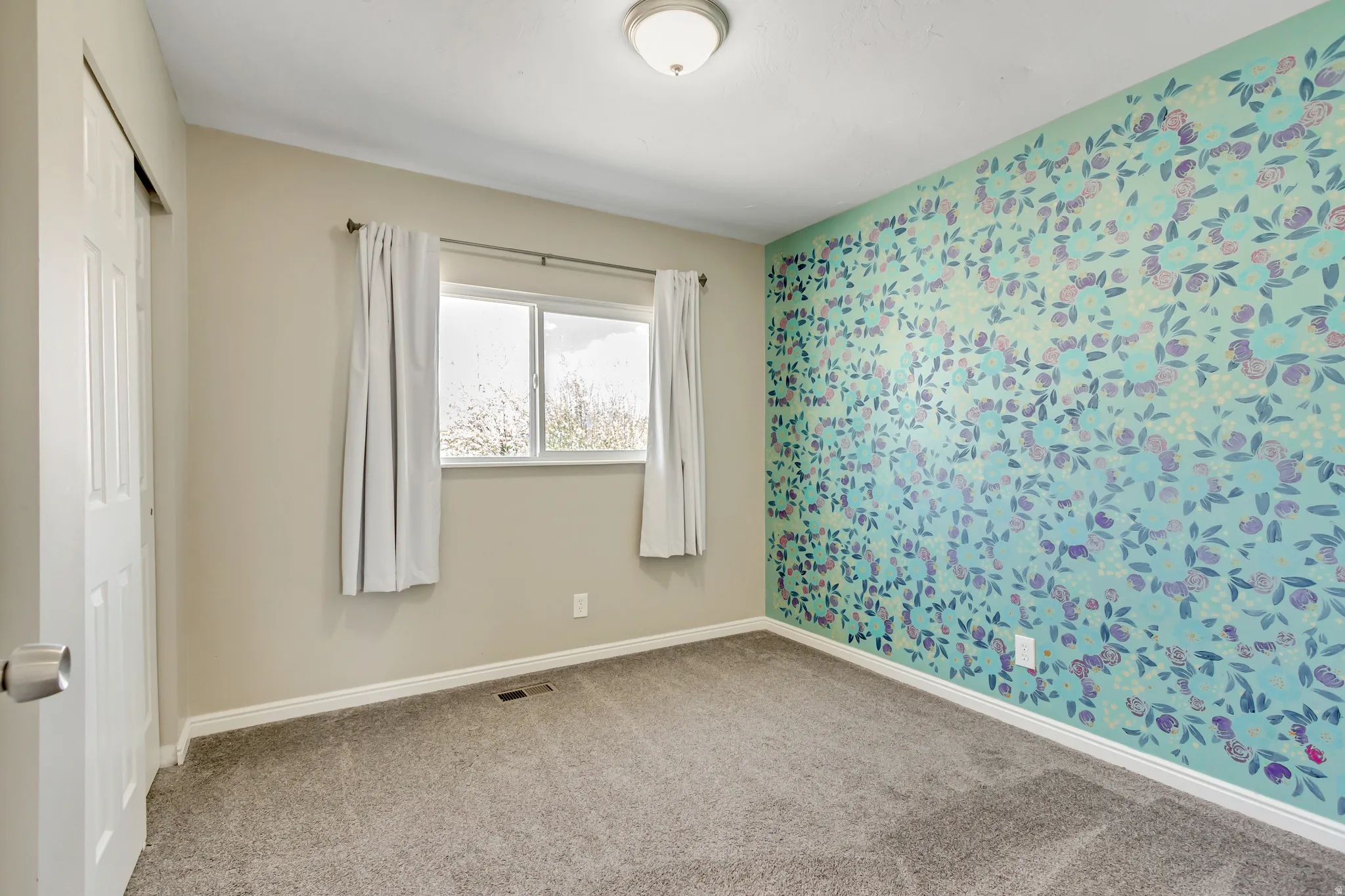 Unfurnished bedroom featuring carpet, a closet, and wallpapered walls