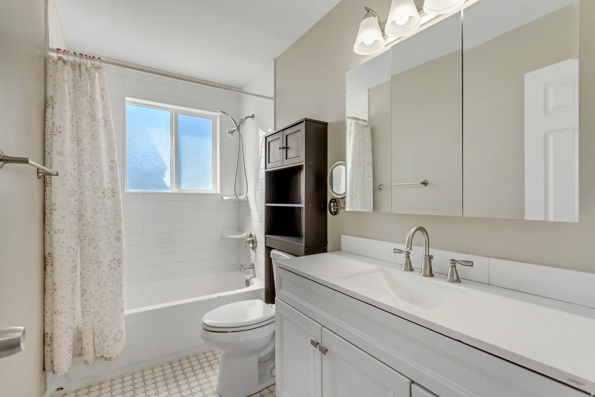 Bathroom featuring vanity and shower / tub combo with curtain