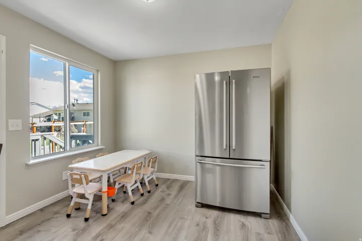 Dining room featuring light wood-type flooring and baseboards