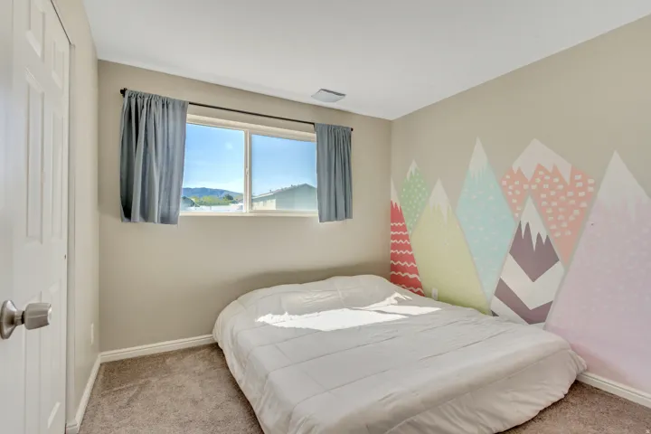 Bedroom with light carpet and a closet