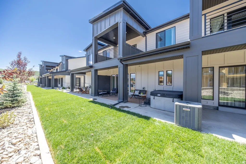 Modern exterior featuring board and batten siding and multiple balconies
