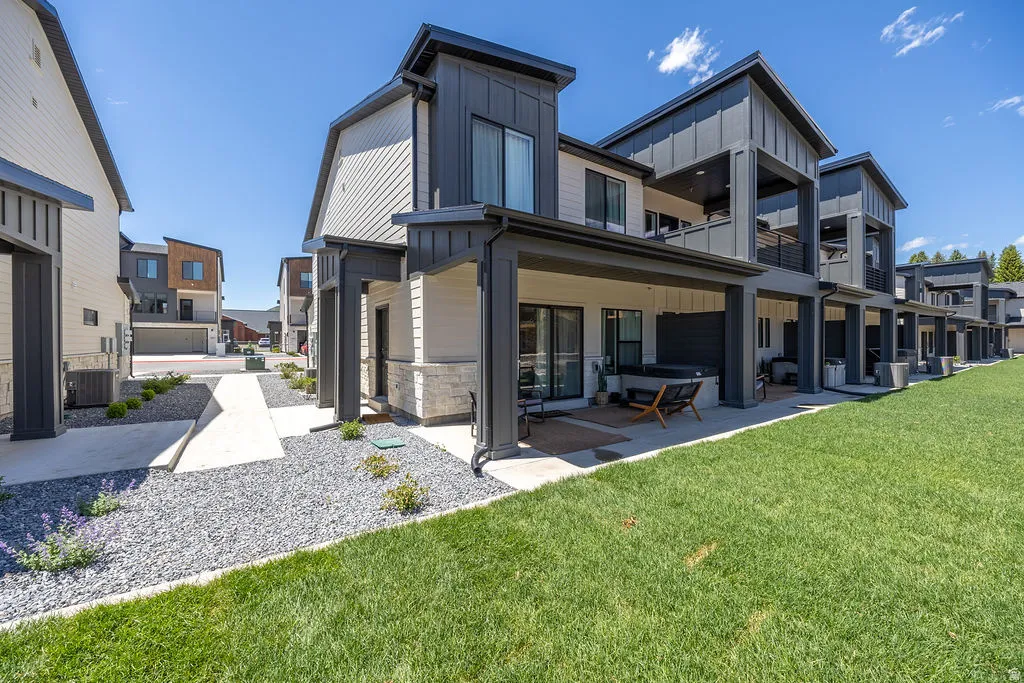 Modern multi-story exterior with dark vertical siding accents and light horizontal siding