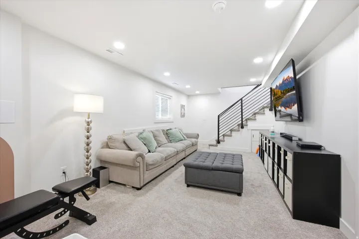 Living room with light colored carpet and recessed lighting