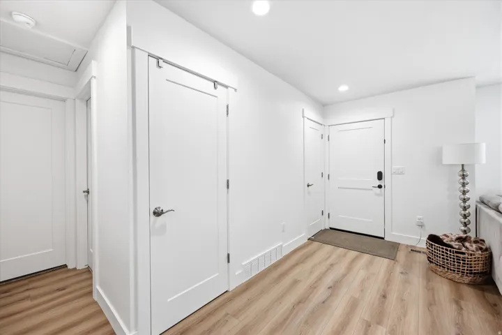 Foyer entrance with light wood-type flooring and recessed lighting