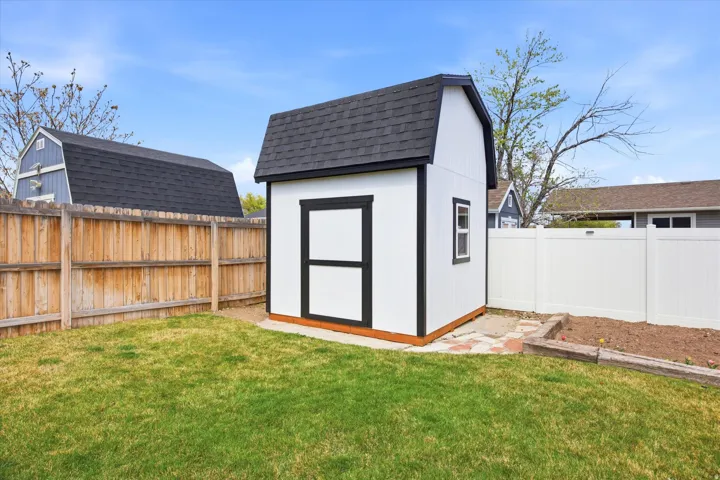 View of shed with a fenced backyard