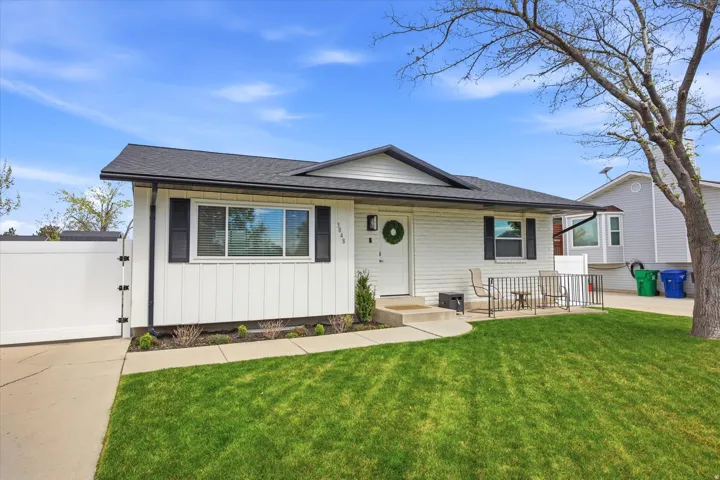 View of front of home featuring a gate and roof with shingles