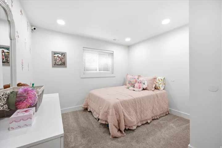 Bedroom featuring light carpet and recessed lighting