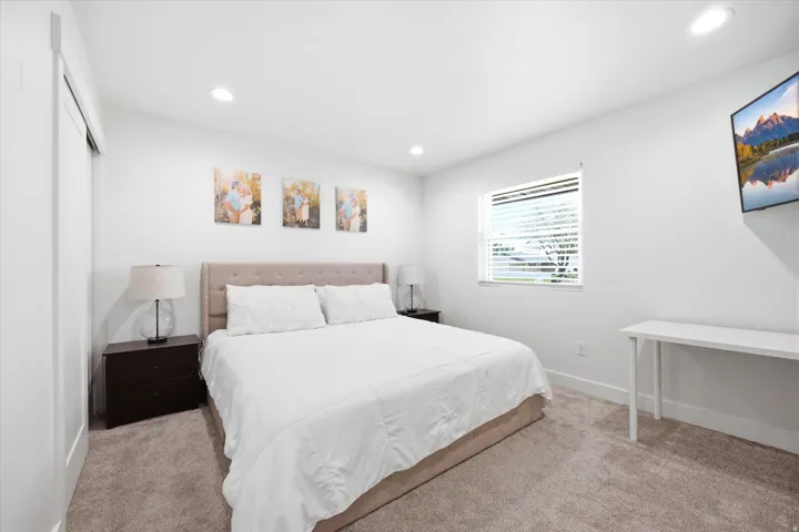Bedroom featuring light carpet and recessed lighting
