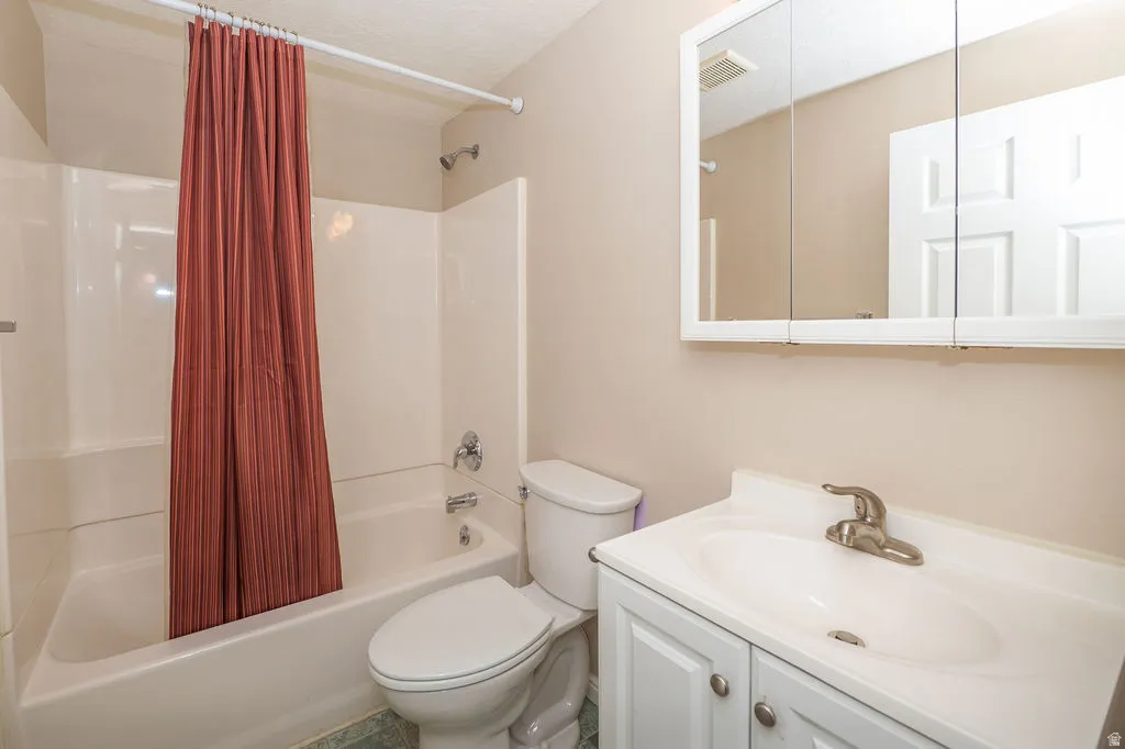 Full bathroom with shower / bath combo.