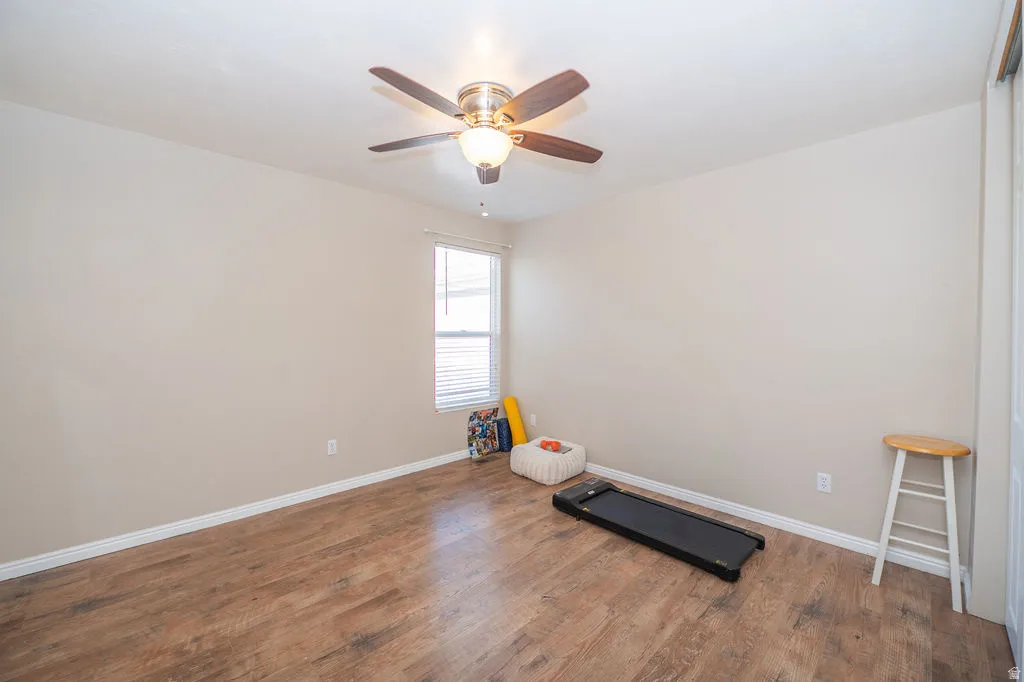 West primary bedroom (smaller than the east bedroom) with LVP flooring, large closet, and west facing window.