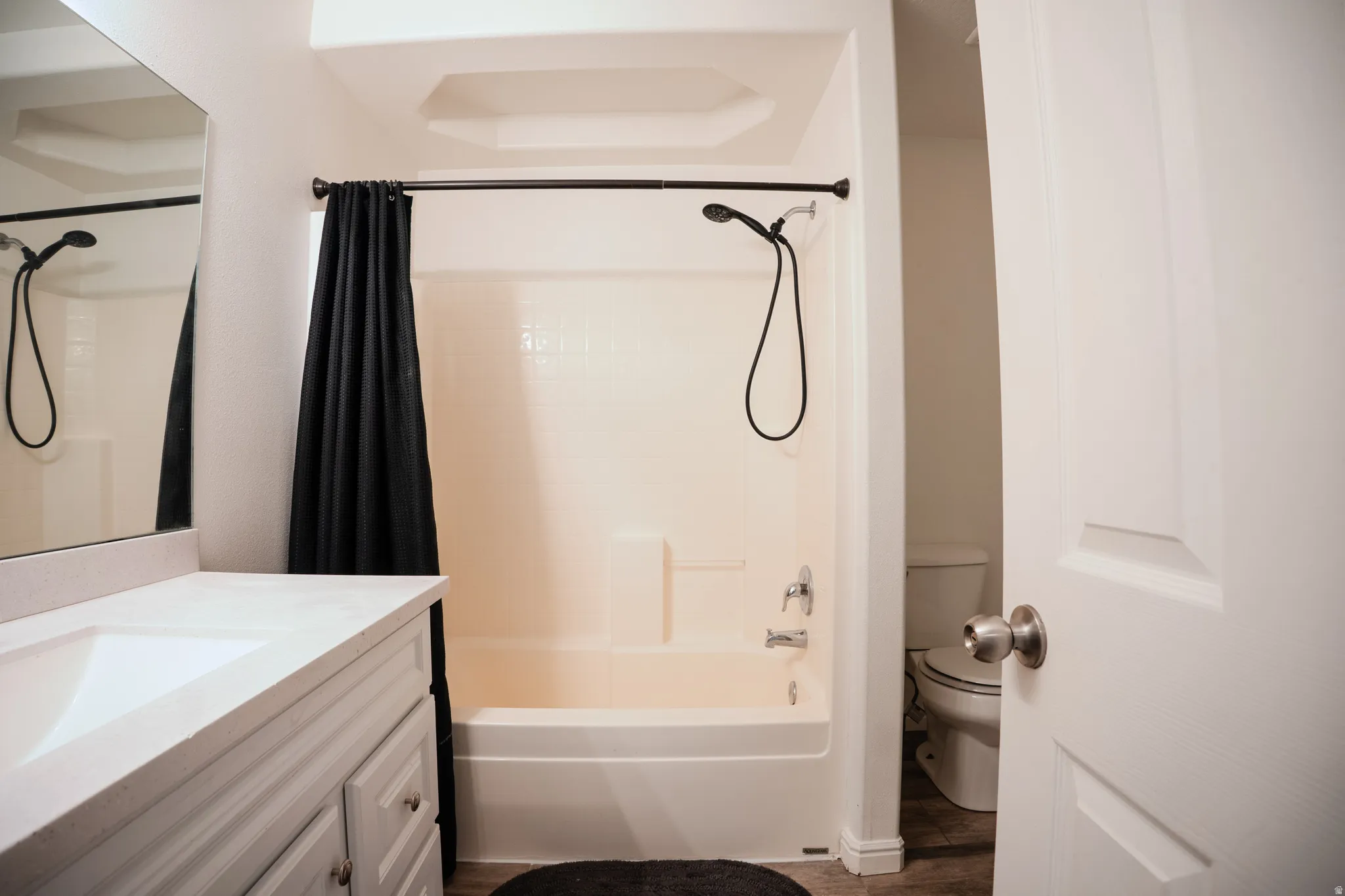 Bathroom with vanity and shower / tub combo with curtain