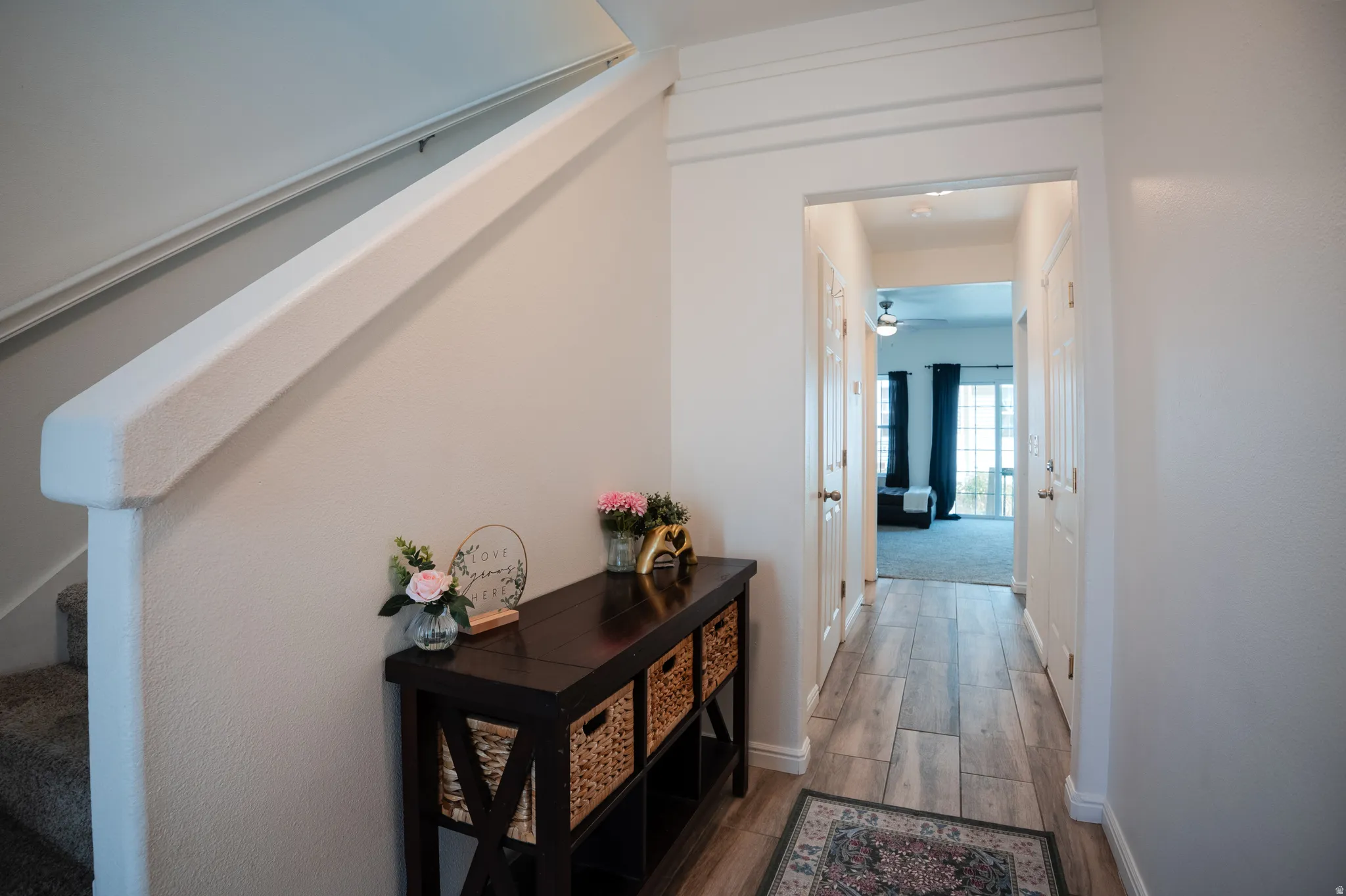 Corridor with light wood-type flooring and baseboards