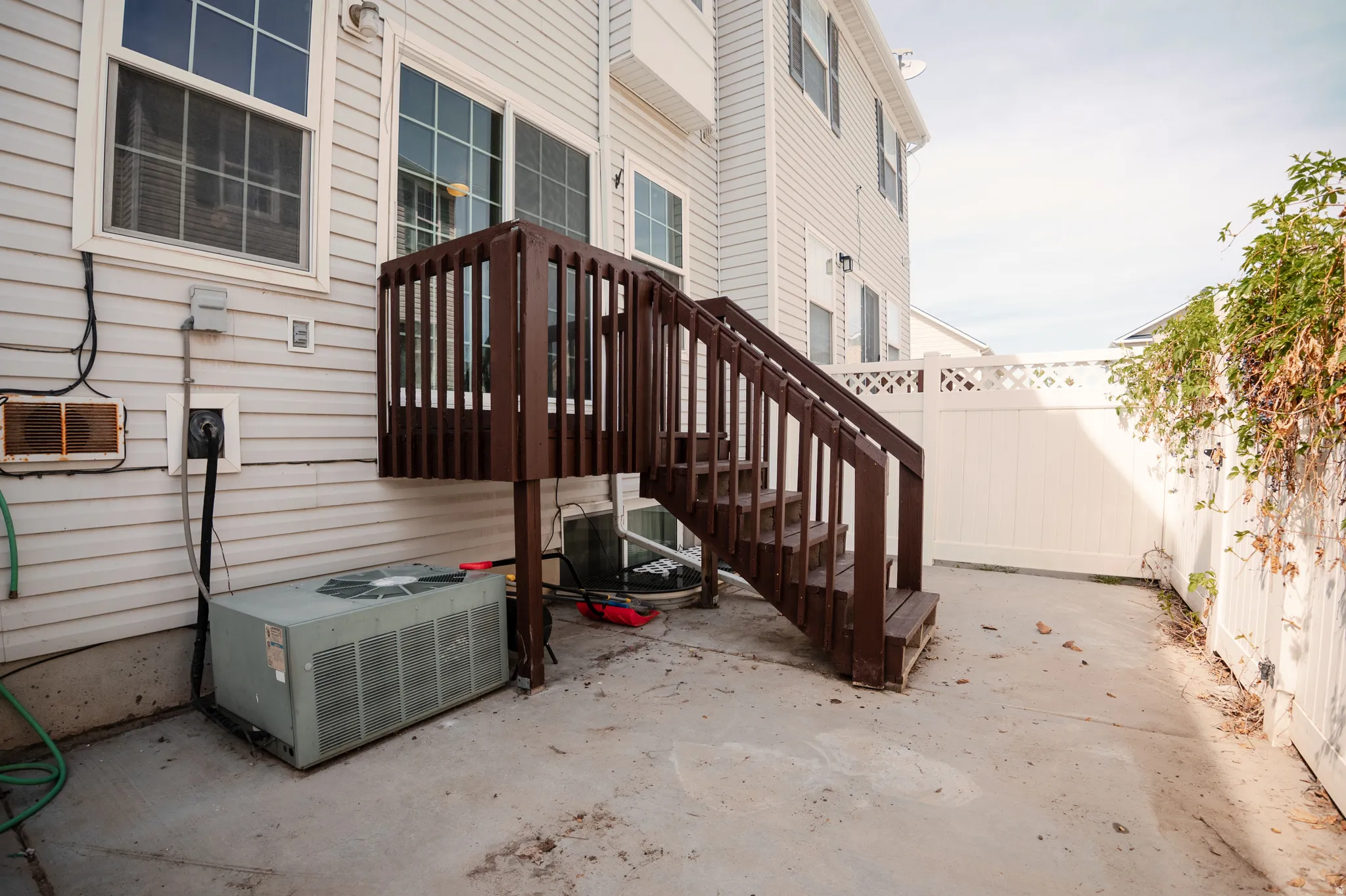 Doorway to property featuring a patio and a wall mounted AC