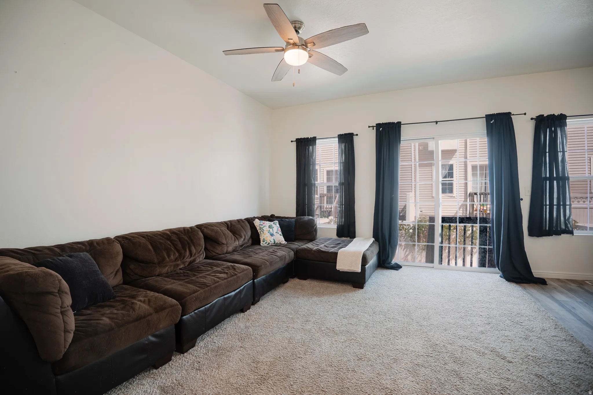 Living area with carpet and ceiling fan