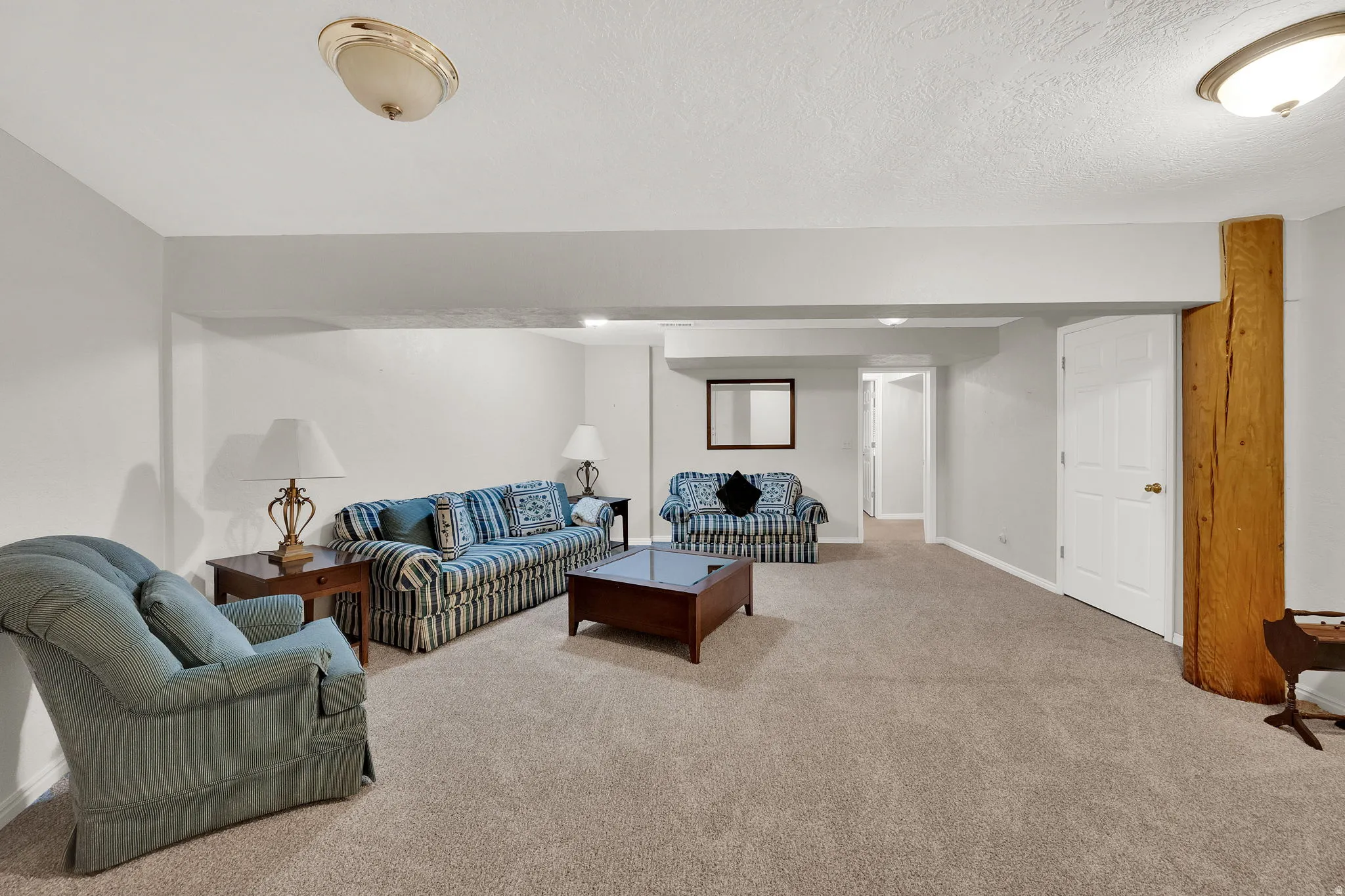 Living room with light carpet and a textured ceiling