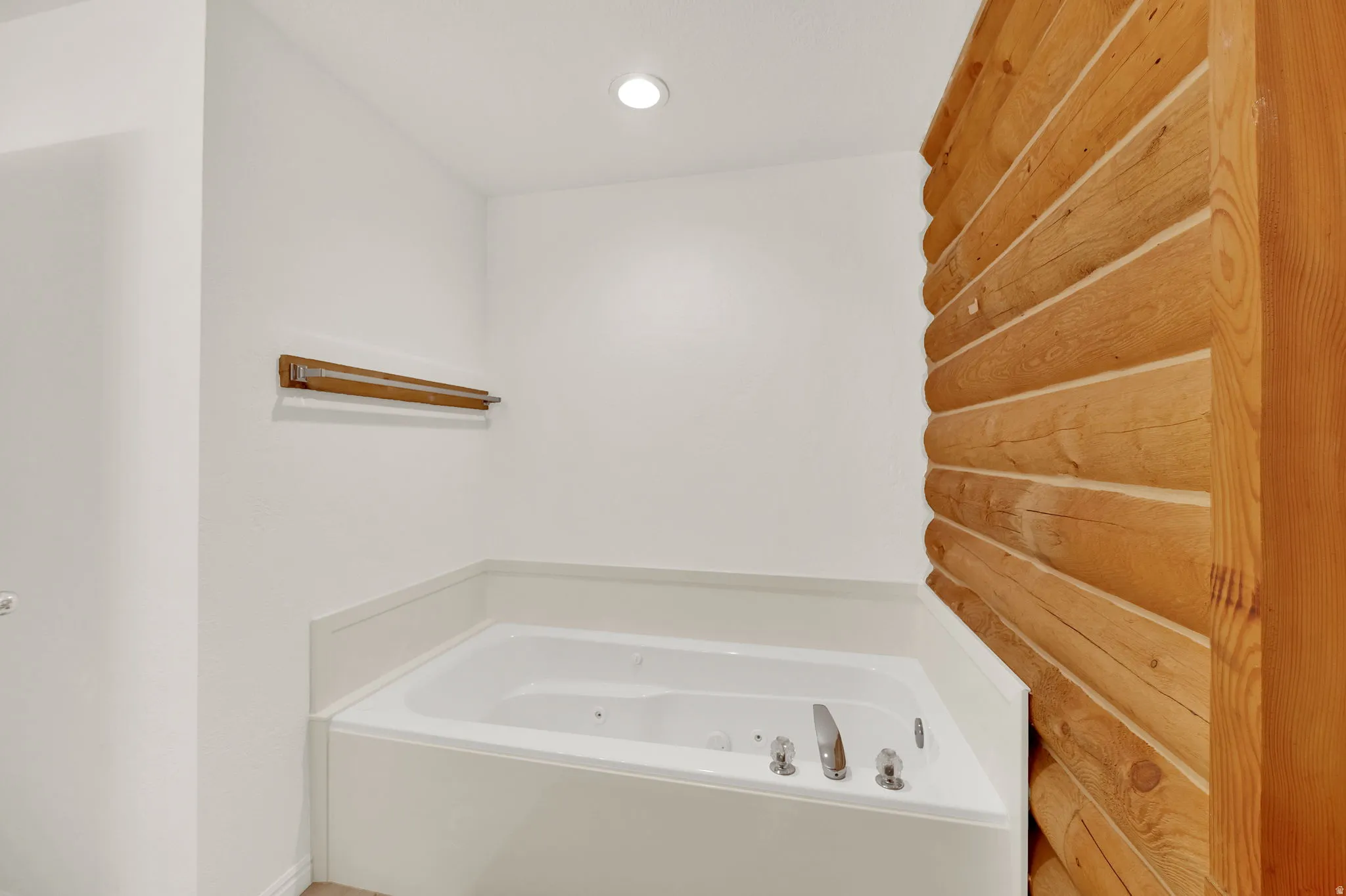 Bathroom featuring a jetted tub and recessed lighting