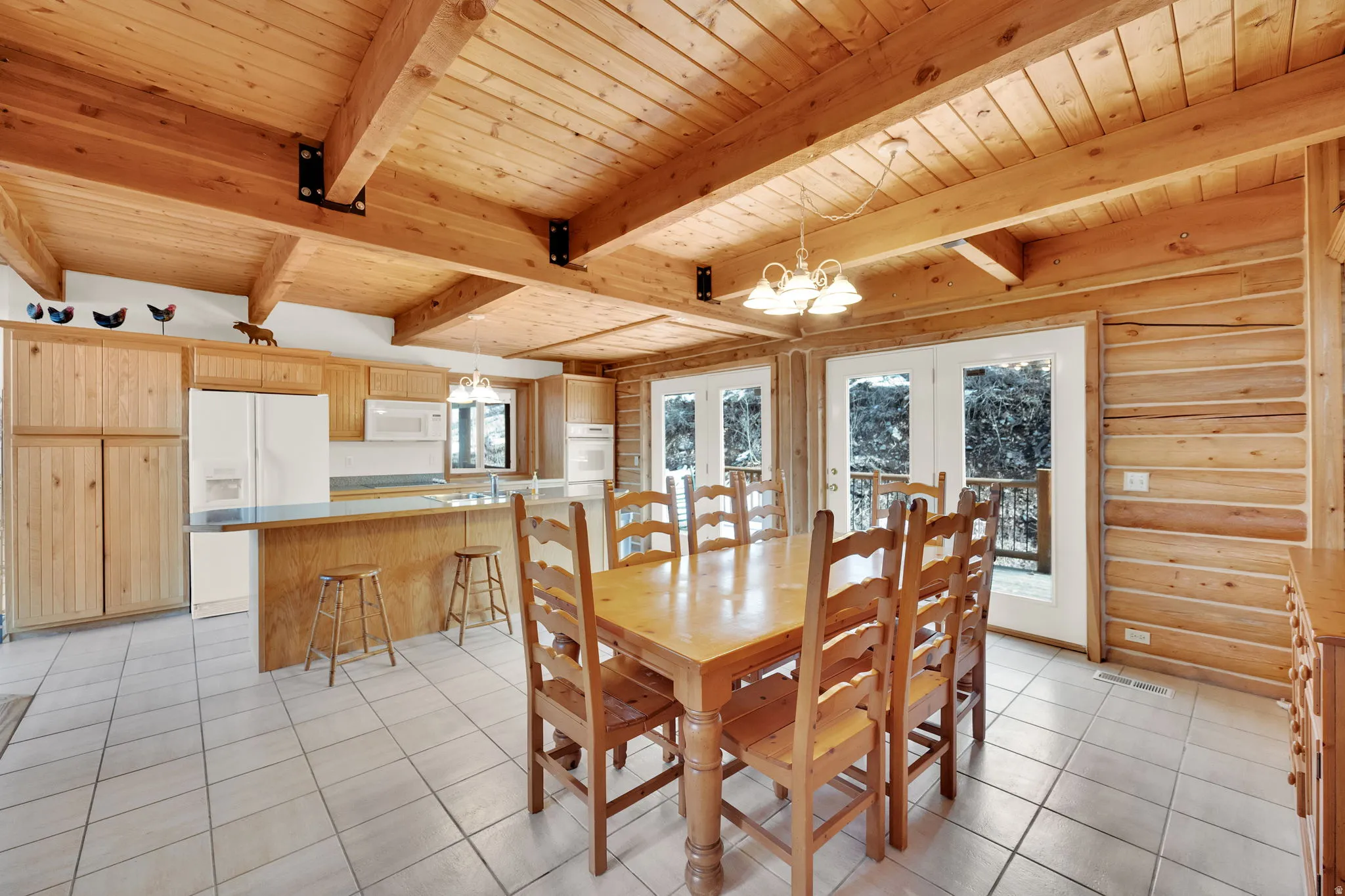 Dining space with suspended lighting, log walls, a wood ceiling with exposed beams, french doors, and light tile patterned flooring