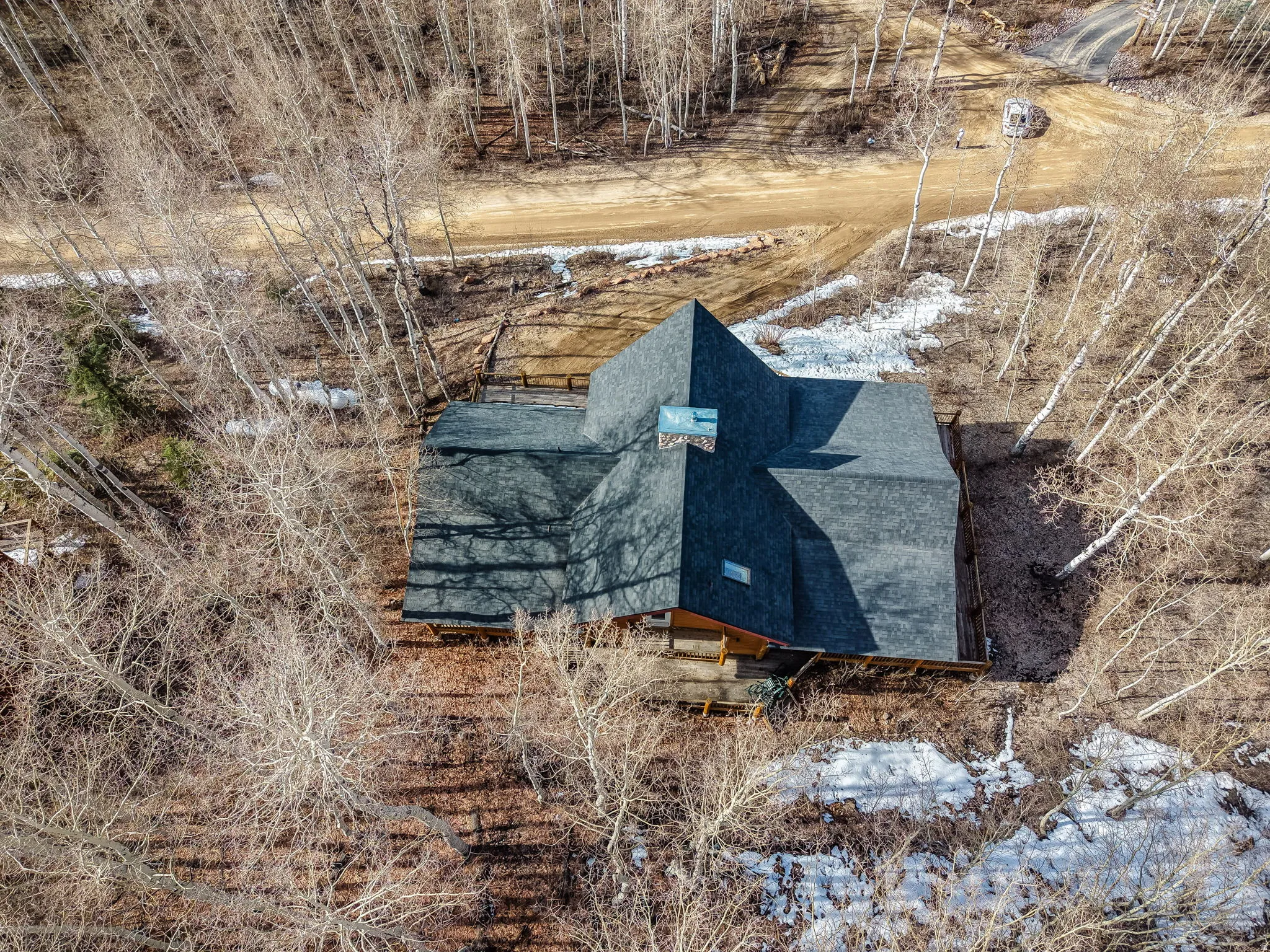 View of subject property with a tree filled landscape