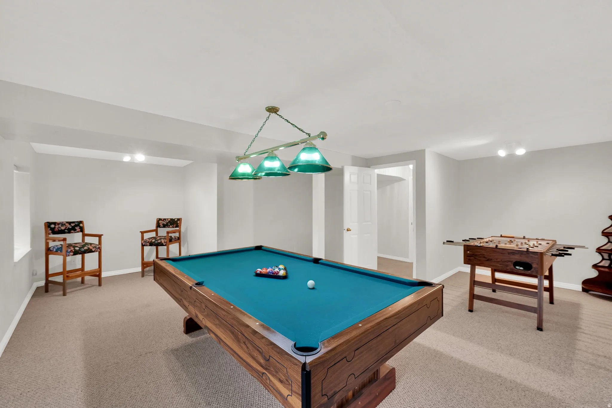Recreation room with light colored carpet and billiards table