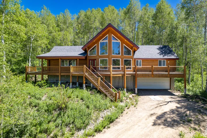 Wood-sided home with a prominent gable featuring extensive window placement