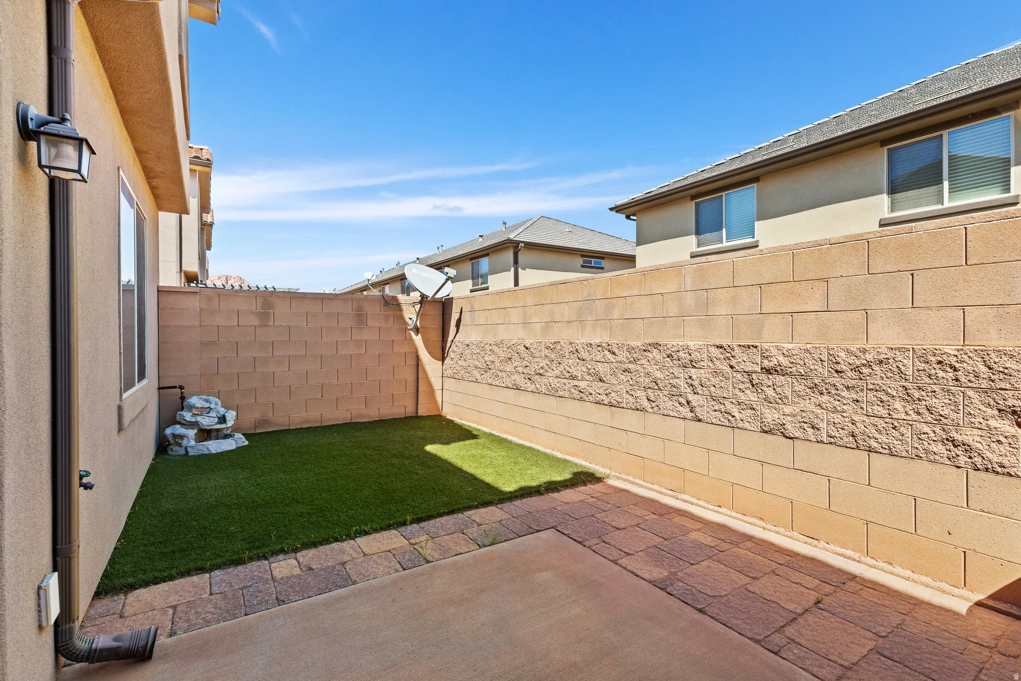Fenced backyard with a patio area