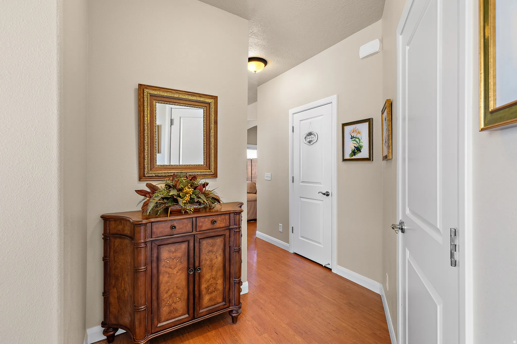 Corridor with baseboards and light wood-style floors