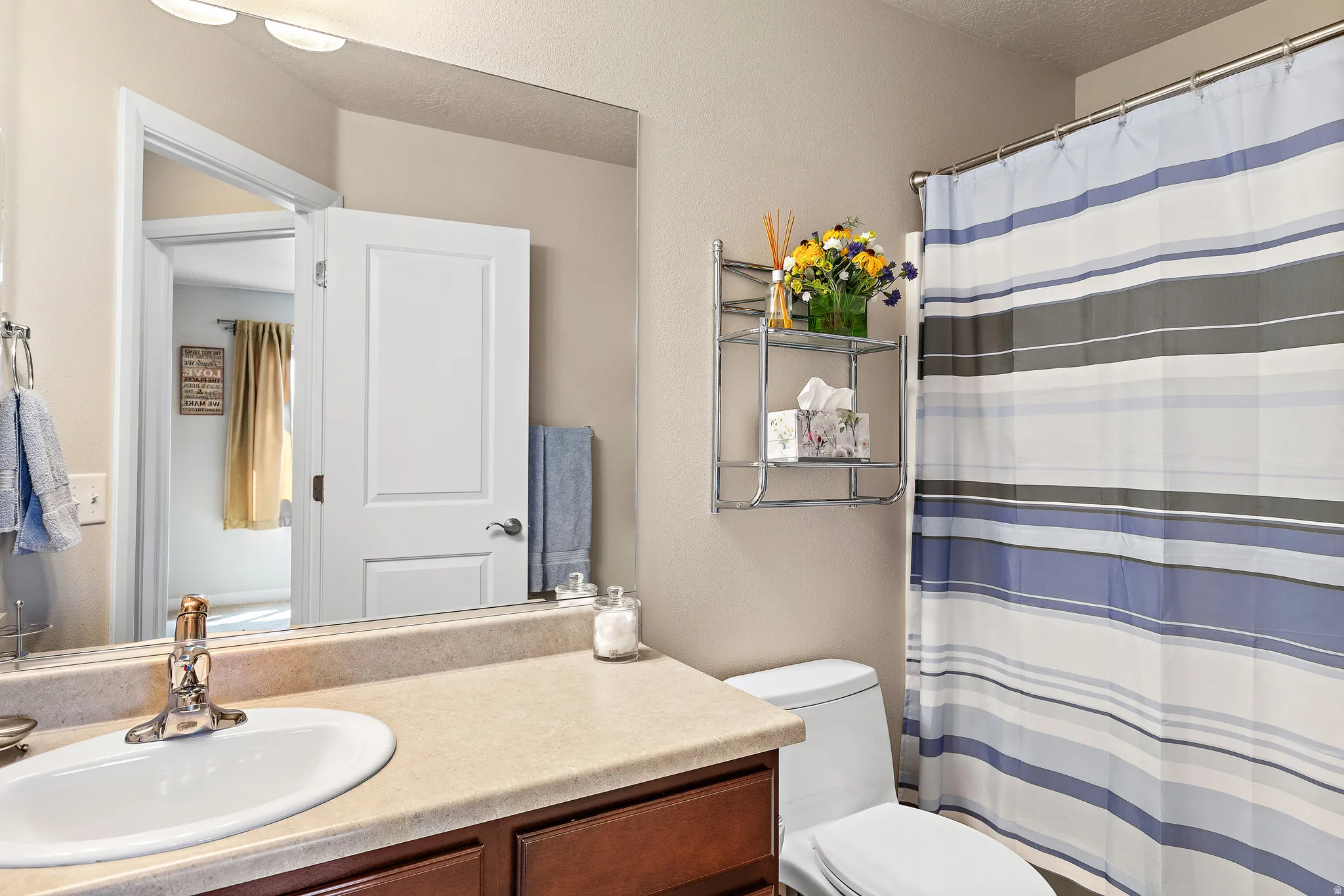 Bathroom featuring a shower with curtain and vanity